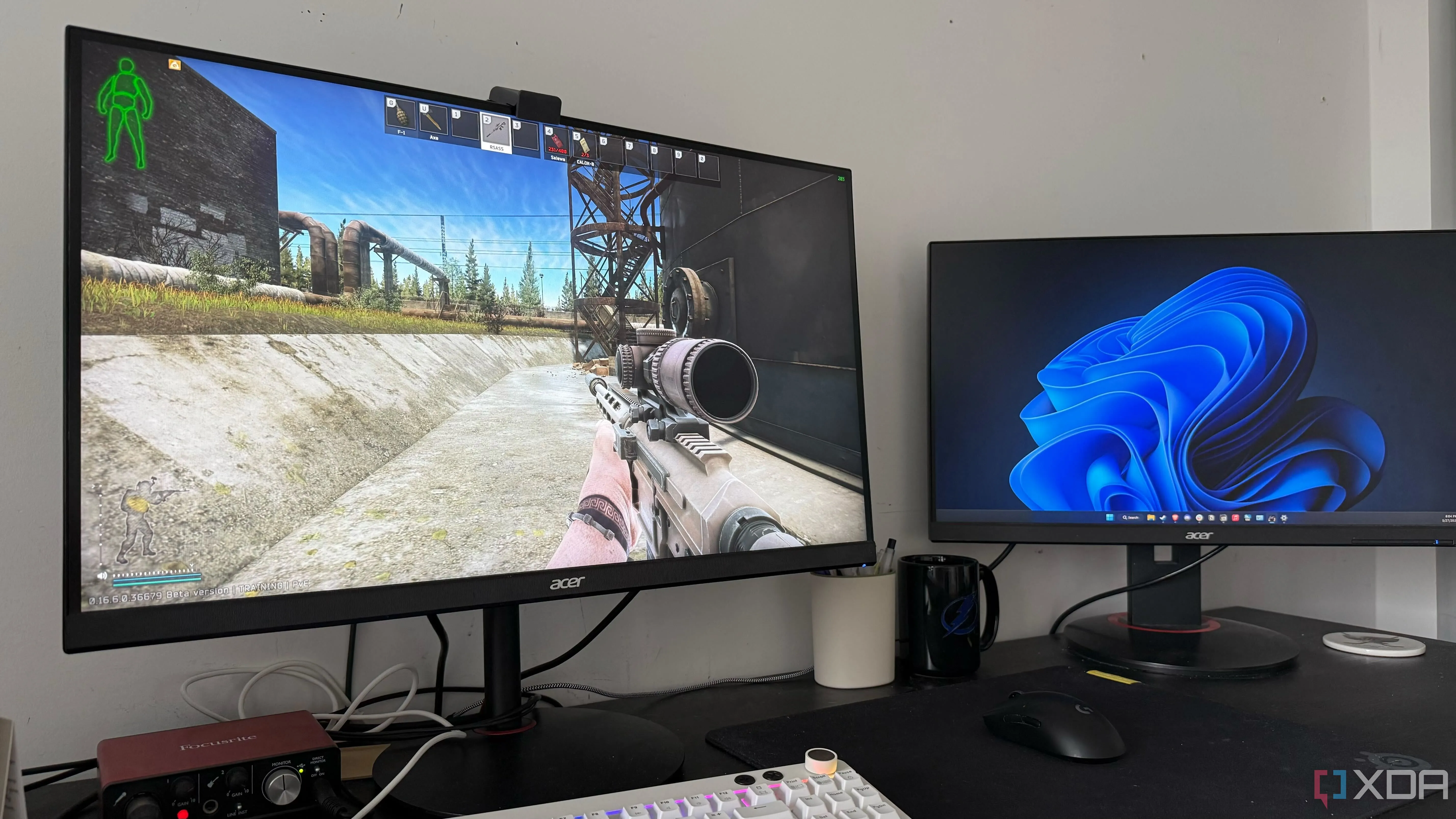 A photo of a gaming setup displaying an FPS game with two monitors