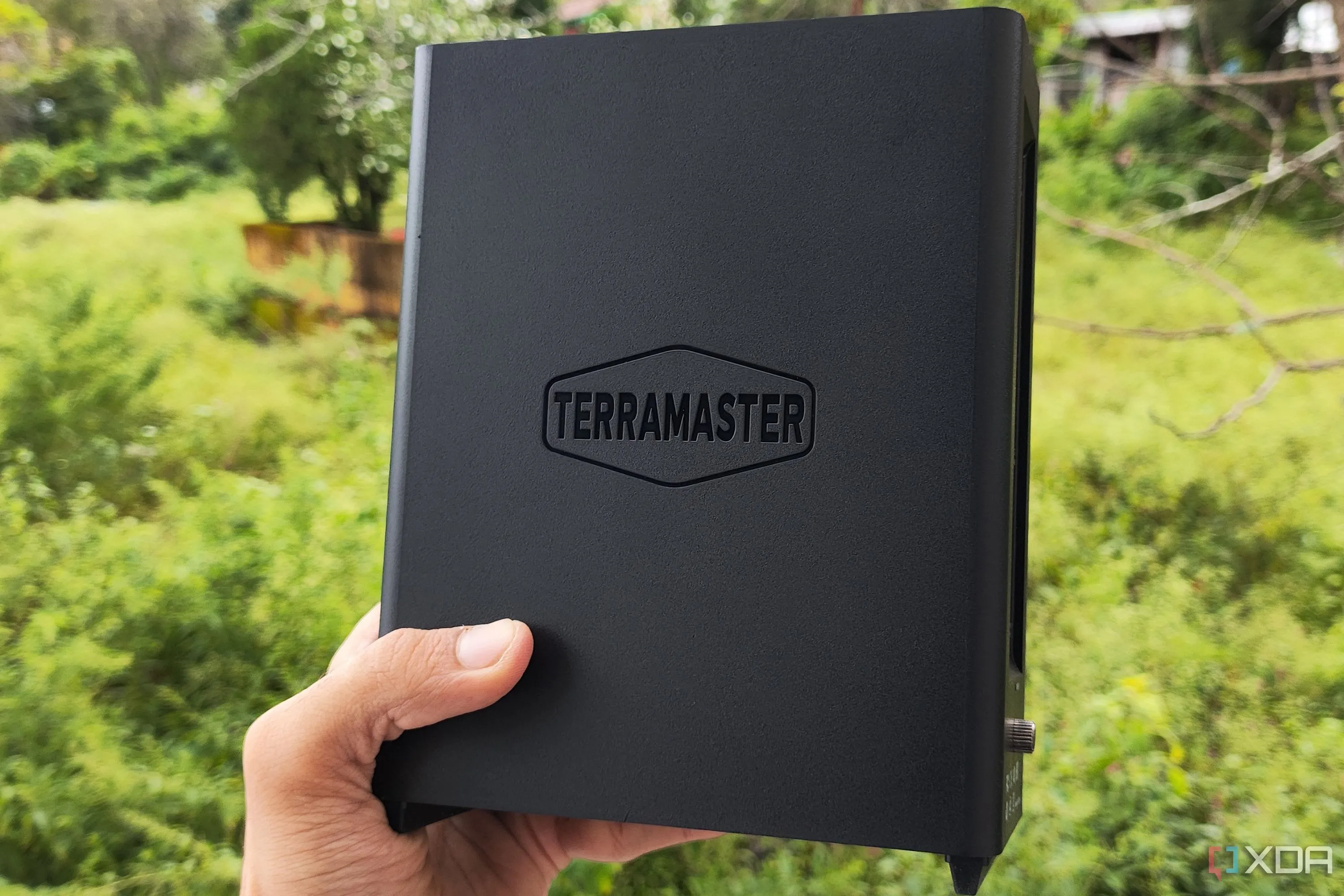 Người dùng cầm thiết bị NAS TerraMaster F8 SSD Plus, biểu tượng cho tốc độ truy cập dữ liệu cao của lưu trữ cục bộ.
