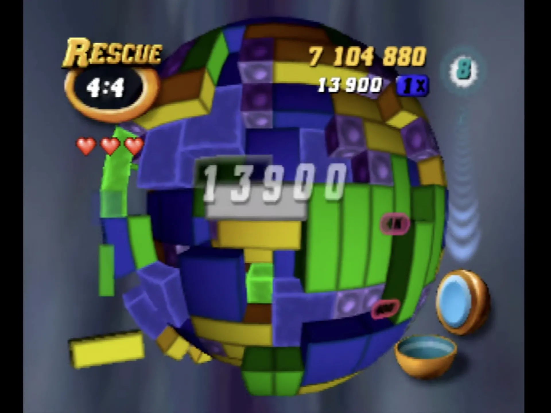 Ảnh chụp màn hình game giải đố 3D Tetrisphere trên Nintendo 64, hiển thị các khối Tetris được sắp xếp trên một quả cầu với mục tiêu phá hủy chúng.