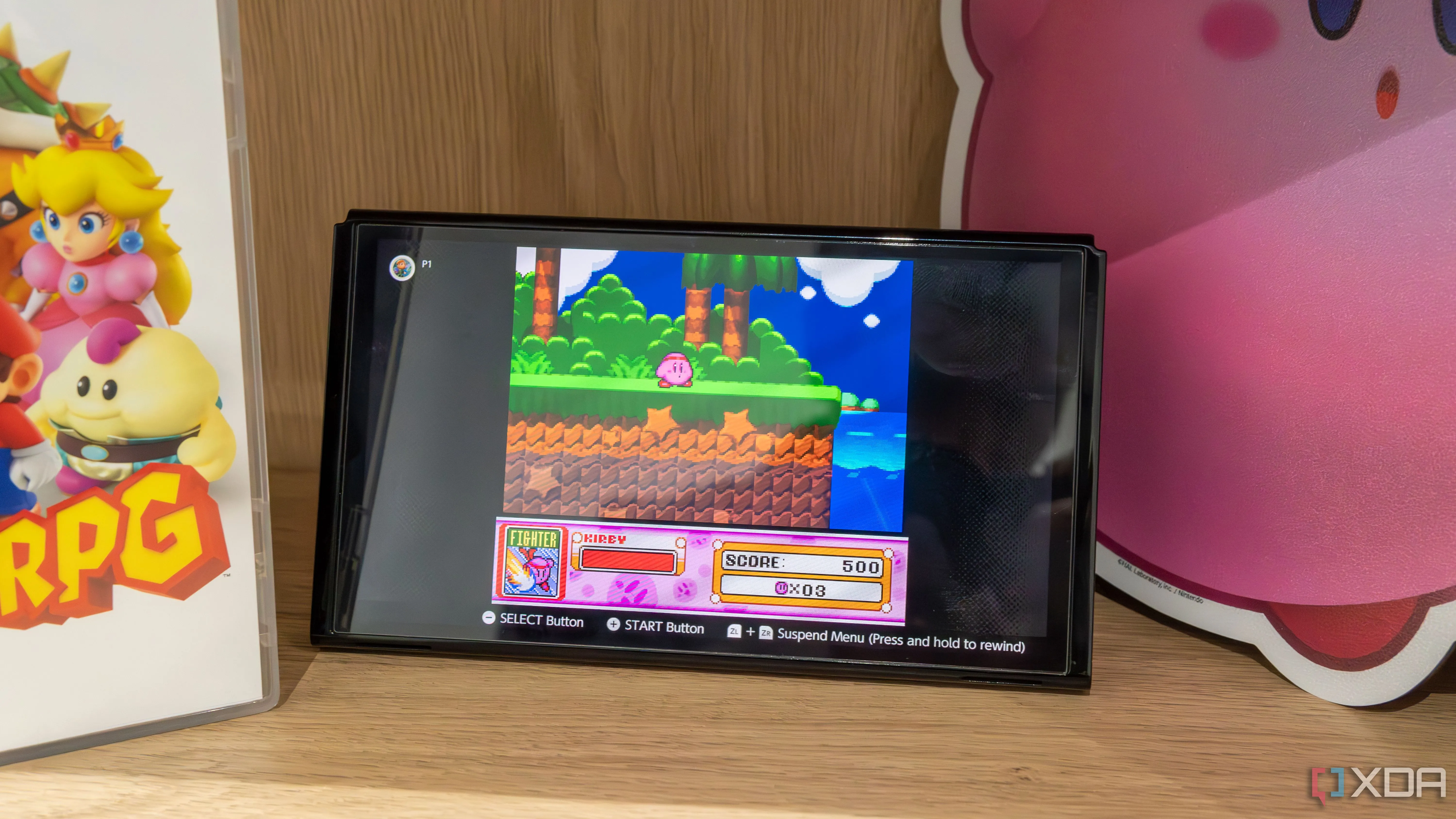 Máy Nintendo Switch OLED với Joy-Con tháo rời đang hiển thị trò chơi Kirby Super Star trên ứng dụng SNES của Nintendo Switch Online