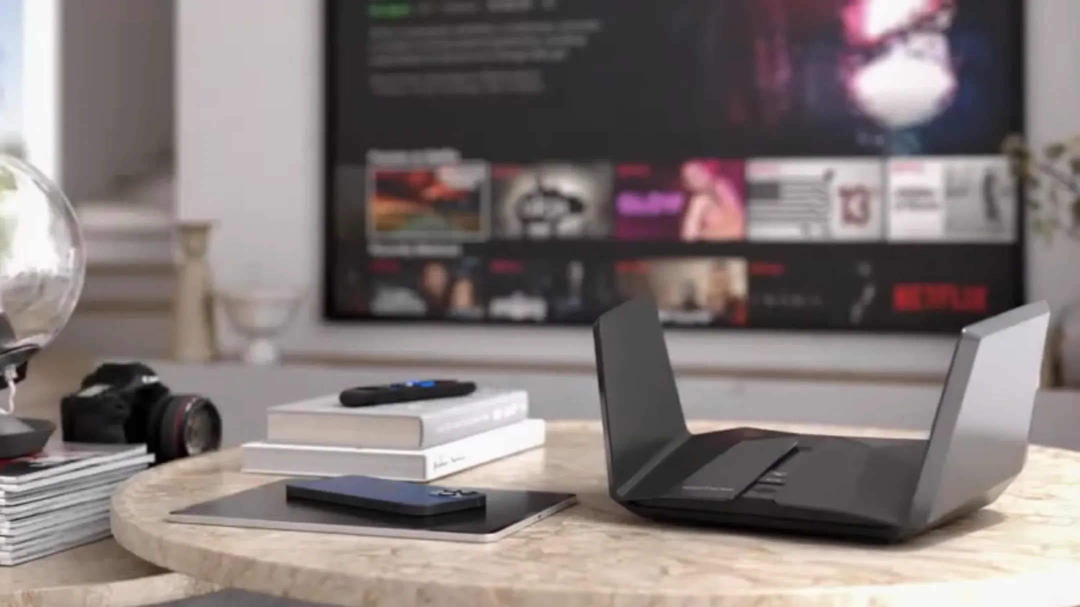 Netgear Nighthawk RAXE500 đặt trên bàn làm việc, thể hiện khả năng phủ sóng Wi-Fi mạnh mẽ
