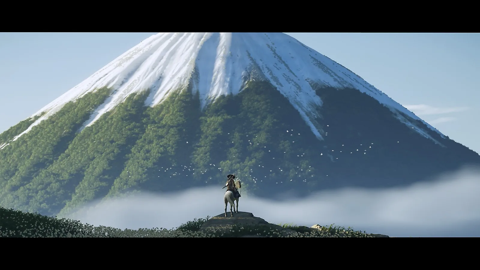 Nhân vật Atsu trong Ghost of Yōtei nhìn ra ngọn núi Yotei hùng vĩ